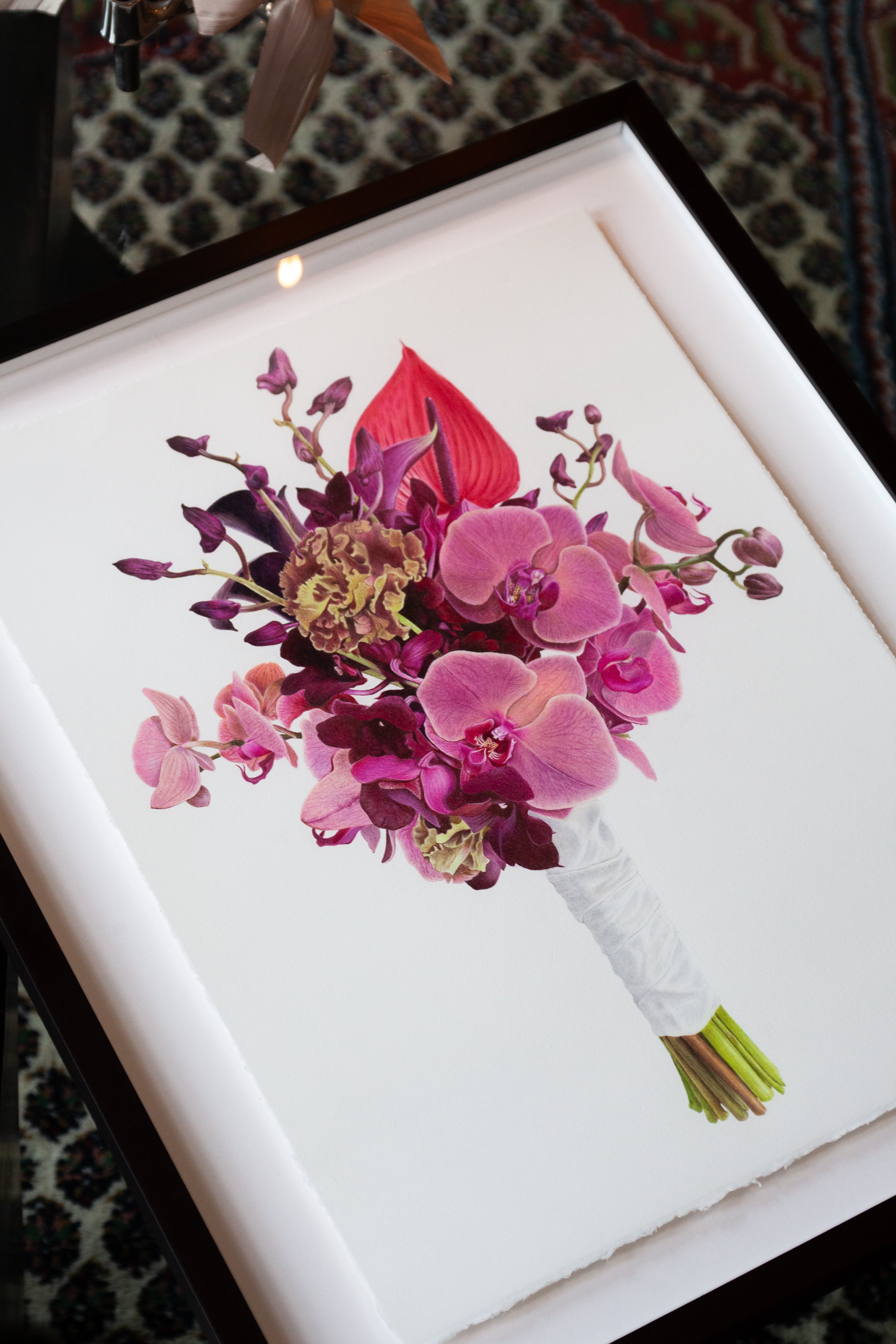 Framed artwork of a bouquet of pink and purple flowers on a white background